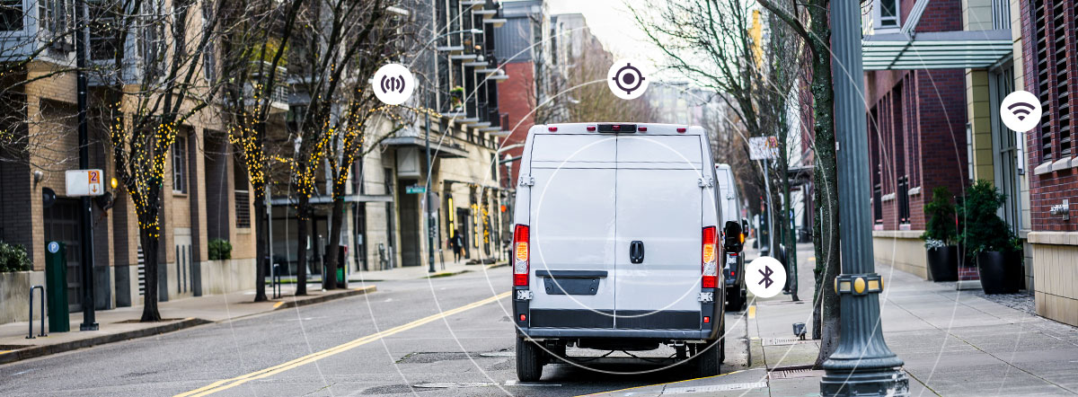 An empty street with a white van parked, circles form a radial wave with symbols of tools that can be used for location detection such as athens, bluetooth and wi-fi